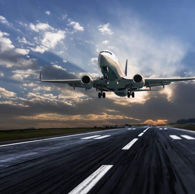 passenger-airplane-landing-at-dusk-royalty-free-image-1569607365